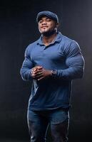 Muscular fitnessman posing in casual cloth. Stylish strongman wear blue clothes. photo