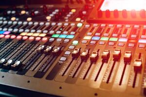 Remote sound engineer. Many buttons of black audio mixer board console. Music equipment. Close-up photo