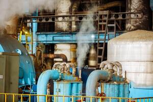 Pipelines and equipment. Steam turbine at power plant. Modern plant with pipeline valves. Power station. photo