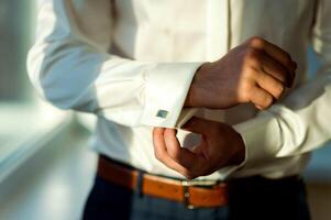 Man in white shirt and cufflink. Mans hands. Groom photosession. Wedding pictures. photo