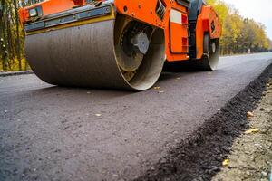 Industrial pavement truck. Laying fresh asphalt on construction site. Heavy machine industry. Mechanical engineering. photo