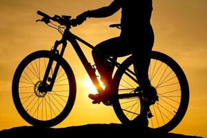 Silhouette of a bike on sky background on sunset. Detailed photo. Closeup photo