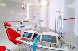 Medical equipment and stomatology concept - interior of new modern dental surgery clinic office with instruments. photo