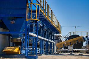 equipment for production of asphalt, cement and concrete. Asphalt factory. Tanks for concrete or rubble. Selective focus. photo