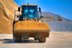 Track-type bulldozer, earth-moving equipment. Land clearing, grading, pool excavation, utility trenching and foundation digging during of large construction jobs. photo