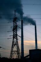 high voltage post. High-voltage tower sky background, factory pipe with smoke over it. Earth pollution concept. Industrialization. Selective focus photo