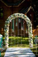 Beautiful wedding arch for the ceremony in the garden in sunny weather photo