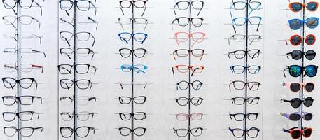 Showcase with spectacles in modern ophthalmic store. Eyeglasses shop. Eyesight correction. photo