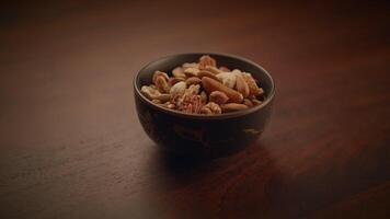 Mixed Nuts of Almonds Pecan Walnuts Cashews Hazelnuts on Wooden Table video