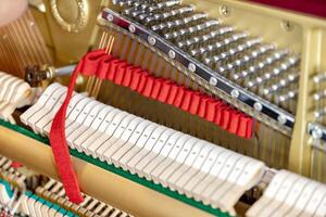 Shallow focus close-up of tools for tuning the internal mechanisms of an upright piano. Gives a feeling of luxury, classic, luxury, grandeur. Pictures can be used on various topics related to music. photo