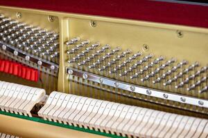 Shallow focus close-up of tools for tuning the internal mechanisms of an upright piano. Gives a feeling of luxury, classic, luxury, grandeur. Pictures can be used on various topics related to music. photo