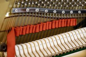 Shallow focus close-up of tools for tuning the internal mechanisms of an upright piano. Gives a feeling of luxury, classic, luxury, grandeur. Pictures can be used on various topics related to music. photo