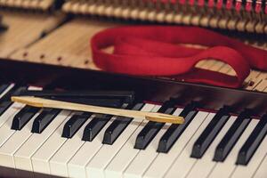 Shallow focus close-up of tools for tuning the internal mechanisms of an upright piano. Gives a feeling of luxury, classic, luxury, grandeur. Pictures can be used on various topics related to music. photo