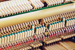 Close-up shallow focus image of the internal mechanisms of an upright piano. It gives a feeling of luxury, beauty, classic, sophistication, elegance. Image can be use for various topics about  music. photo