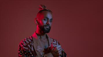 Neon light studio close-up portrait handsome black gay man looking camera. photo