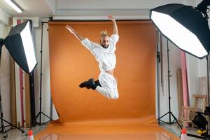 Gay man dancing in photo studio