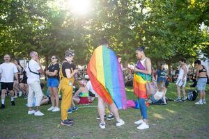 Lisbon, Portugal 17 June 2023 People wearing rainbow flags at Pride Parade photo