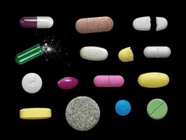 Assorted pills isolated on black. capsules, gel, tablets, drugs etc. oral medication collection. photo