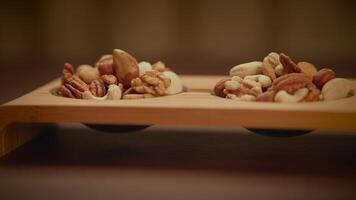 Mixed Nuts of Almonds Pecan Walnuts Cashews Hazelnuts on Wooden Table video