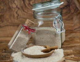 Psyllium seeds and psyllium husks on olive wood photo