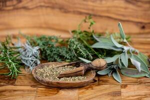 Herbs from French Provence on olive wood photo