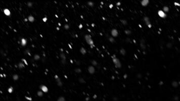 Falling snow with motion blur on black background. Bokeh of white snow on a black background. photo