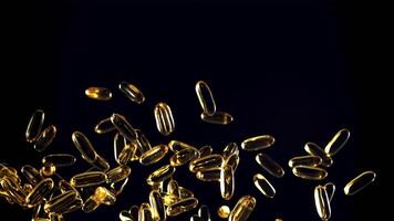 Omega 3 vitamin capsules soar up and fall down. On a black background. Filmed on a high-speed camera at 1000 fps. video