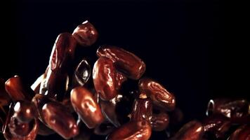 Dates rise up and rotate in flight. On a black background. Filmed on a high-speed camera at 1000 fps. video