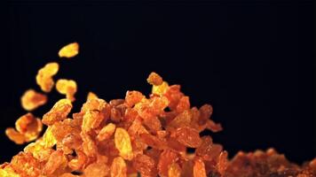 A pile of raisins soars up and falls. On a black background. Filmed is slow motion 1000 fps. video