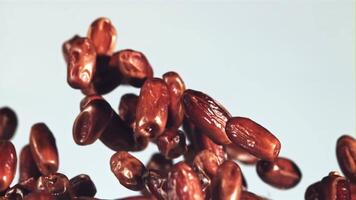 Dates fly up and rotate in flight. On a blue background. Filmed on a high-speed camera at 1000 fps. video