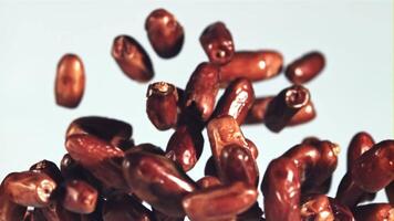 Dates fly up and rotate in flight. On a blue background. Filmed on a high-speed camera at 1000 fps. video