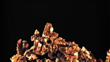 Peeled walnuts take off and rotate in flight. On a black background.Filmed is slow motion 1000 fps. video