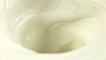 A whirlpool of milk. Macro background. Filmed on a high-speed camera at 1000 fps. High quality FullHD footage video