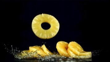 Pieces of pineapple fall on the wet table. Filmed is slow motion 1000 fps. High quality FullHD footage video