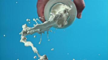 The milk is poured out of the bottle. Filmed on a high-speed camera at 1000 fps. High quality FullHD footage video