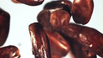 Dates fly up and rotate in flight. On a white background. Filmed is slow motion 1000 fps. video