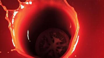 A piece of tomato with splashes falls into the tomato juice. Top view.Filmed on a high-speed camera at 1000 fps. video