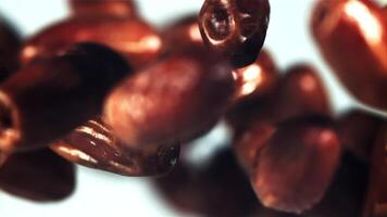 Dates fly up and rotate in flight. On a white background. Filmed is slow motion 1000 fps. video