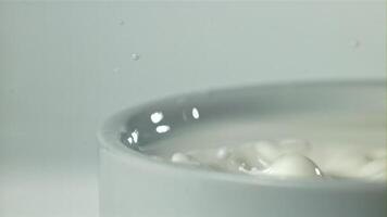 Splashes from a drop of milk. Filmed on a high-speed camera at 1000 fps. High quality FullHD footage video