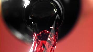 Red wine is poured out of the bottle. Filmed on a high-speed camera at 1000 fps. High quality FullHD footage video