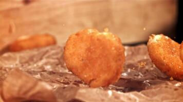 Chicken nuggets fall on the table. Filmed on a high-speed camera at 1000 fps. High quality FullHD footage video