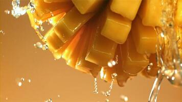 Drops of water drip from fresh mango. Filmed on a high-speed camera at 1000 fps. High quality FullHD footage video