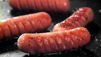 Sausages are fried with splashes in a pan. Filmed on a high-speed camera at 1000 fps. High quality FullHD footage video