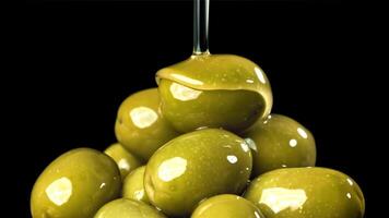 Olive oil is poured over fresh olives. Filmed on a high-speed camera at 1000 fps. High quality FullHD footage video