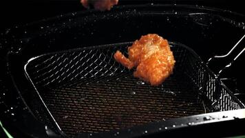 Chicken nuggets fall into hot oil. Filmed on a high-speed camera at 1000 fps. High quality FullHD footage video