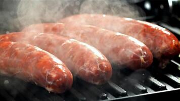 Sausages are fried with splashes in a pan. Filmed on a high-speed camera at 1000 fps. High quality FullHD footage video