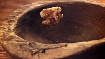 Walnuts fall into a wooden bowl. Filmed on a high-speed camera at 1000 fps. High quality FullHD footage video