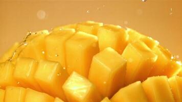 Raindrops fall on fresh mango. Filmed on a high-speed camera at 1000 fps. High quality FullHD footage video