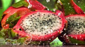 Drops of water fall on a tropical dragon fruit. Filmed on a high-speed camera at 1000 fps. High quality FullHD footage video