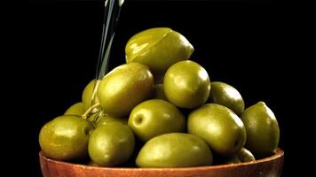 Olive oil is poured over fresh olives. Filmed on a high-speed camera at 1000 fps. High quality FullHD footage video